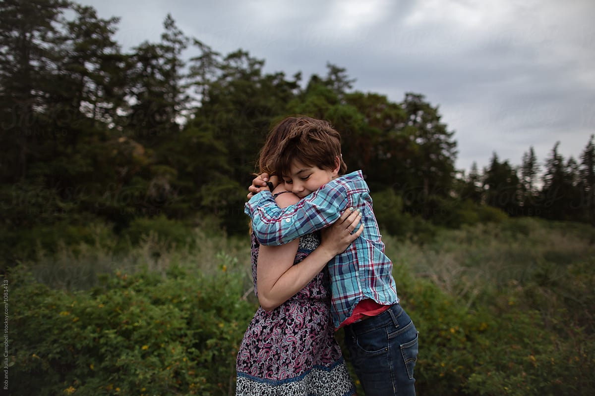 Mom And Son Spending Time Together Outside In Nature Hug By Stocksy Contributor Rob And
