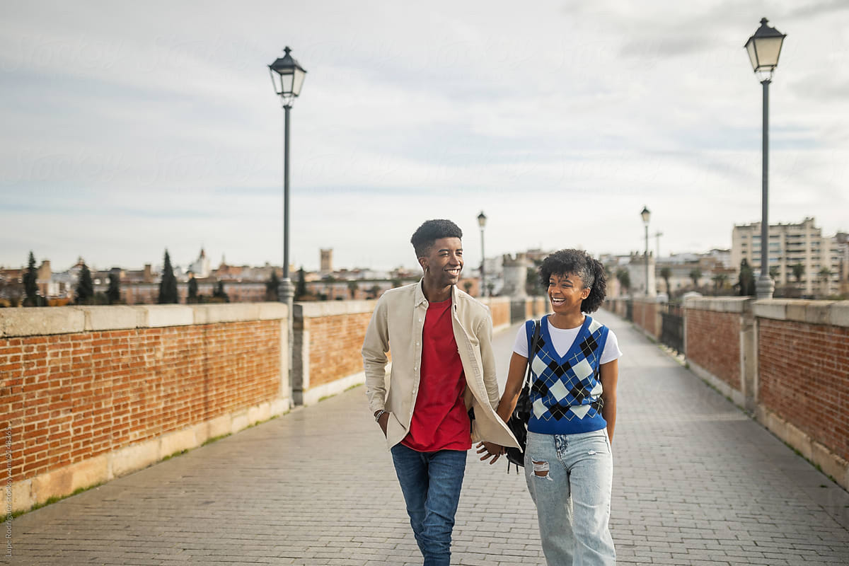 young black couple walking happily in the city