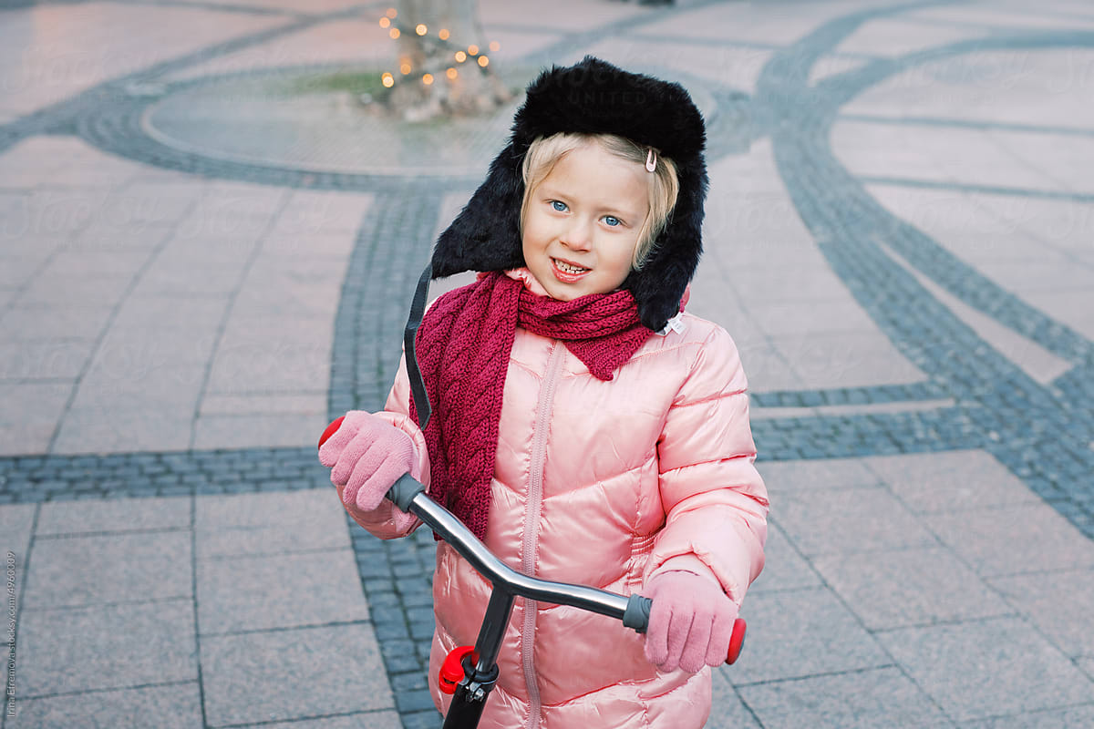 Festive Joy: Little Girl in Pink and kick scooter