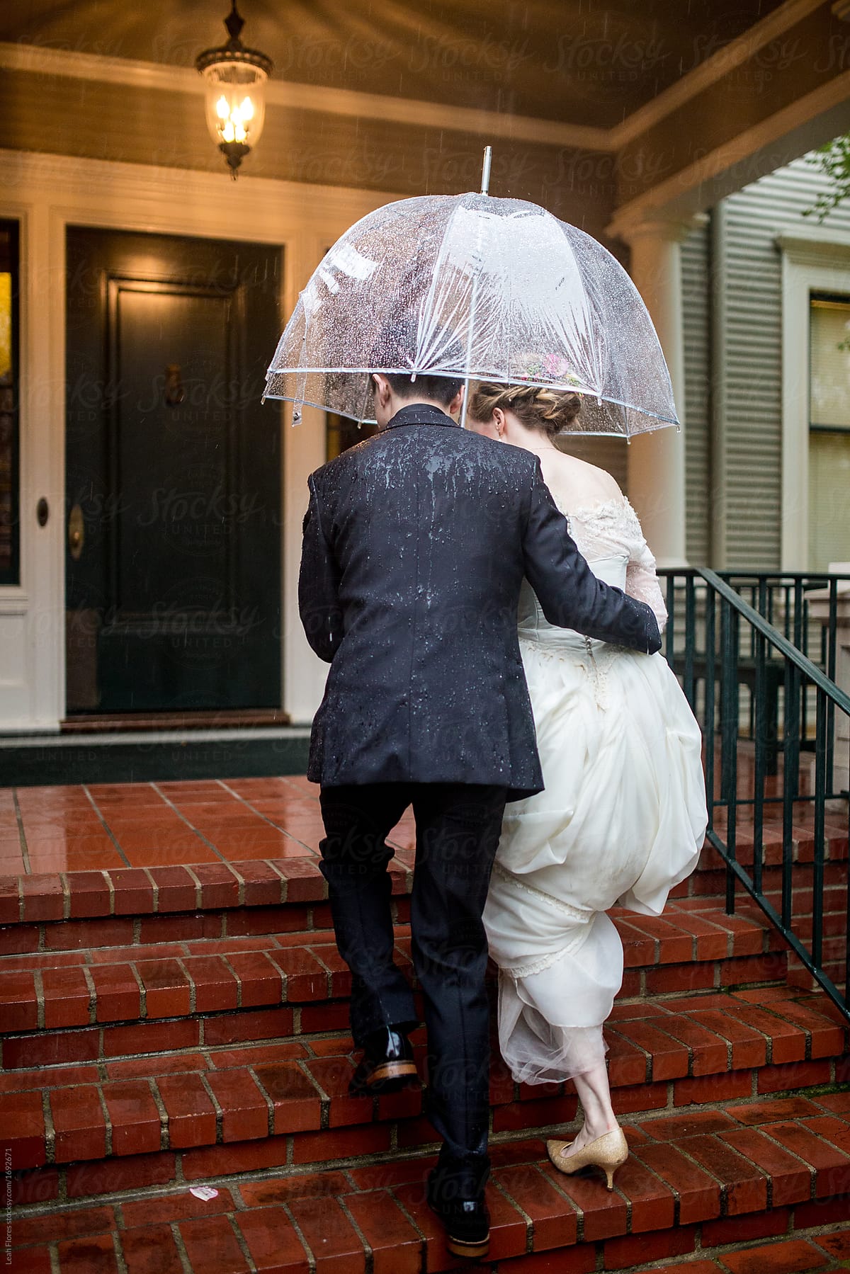Wedding Couple Walking up Stairs in the Rain