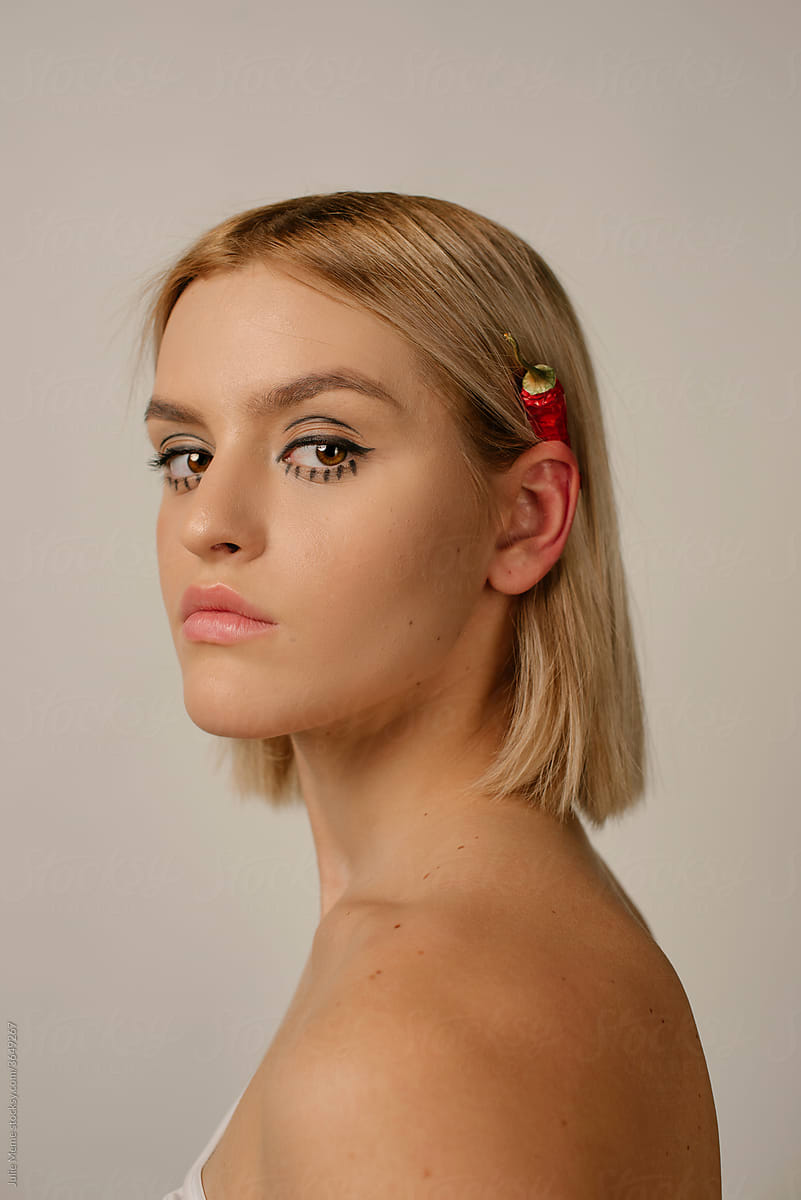 Side Profile of a Young Woman With hot pepper