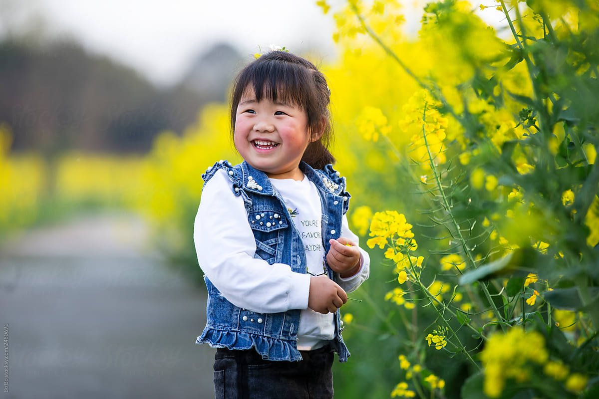 Happy little asian girl in spring field