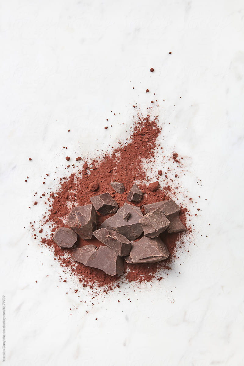 Chunks of chocolate and cocoa powder in studio