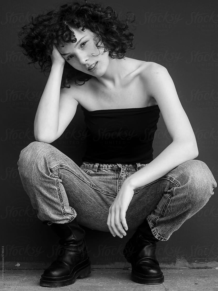 Black and white portrait of a young curly girl model