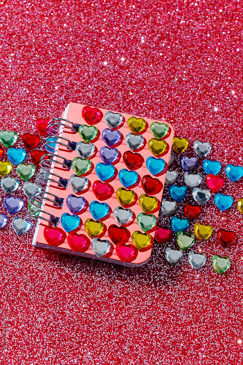 heart-shaped fake jewels on the cover of a notebook