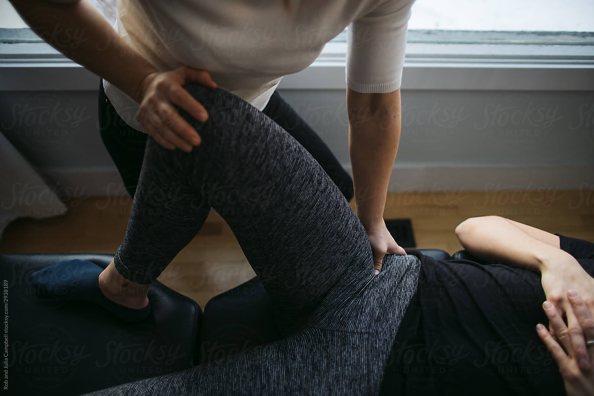 Young woman chiropractor giving treatment.