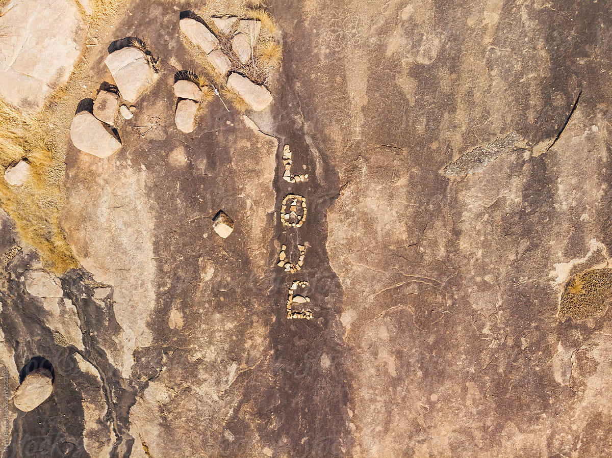 Word love written in stones on granite plateau