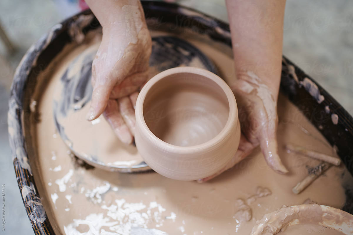 Handmade clay pot in hands