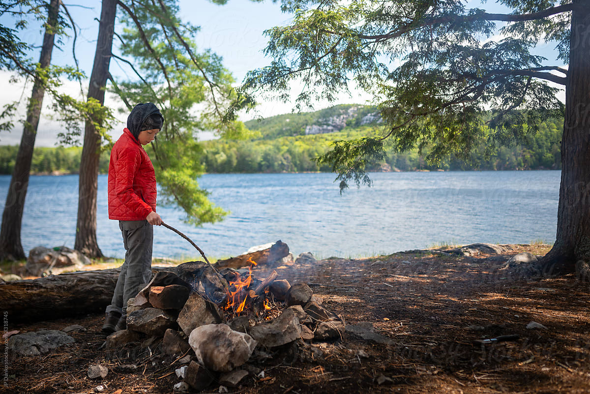 Boy with Campfire on back country Canoe Trip to Northern Lake