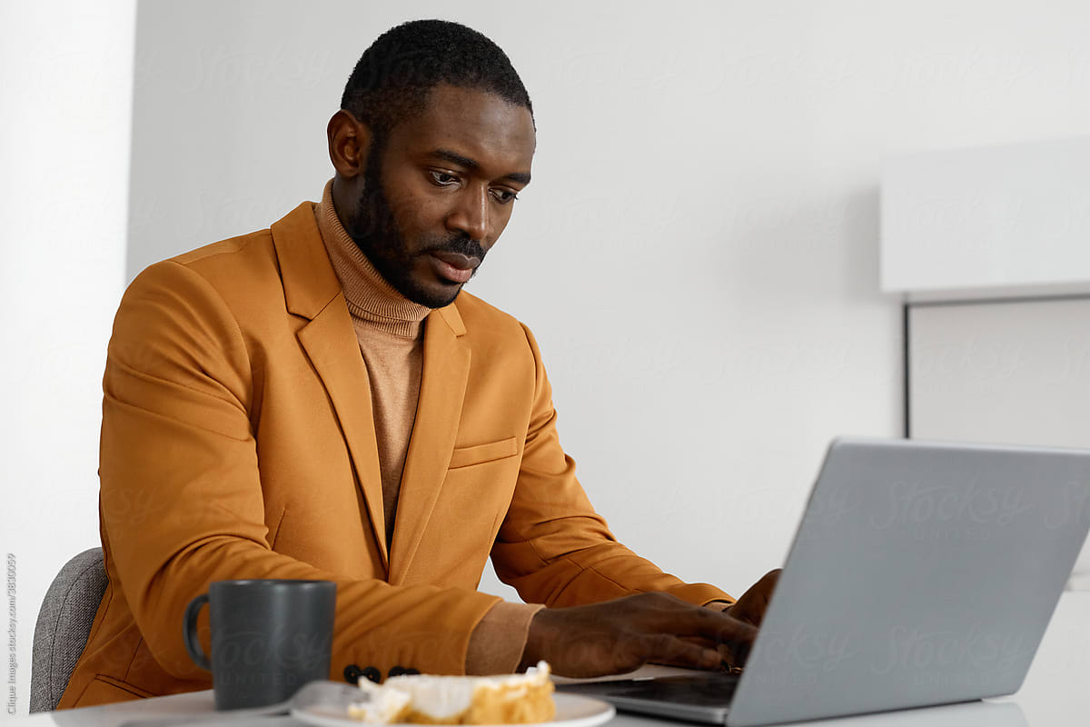 Handsome Black Man Working On Laptop