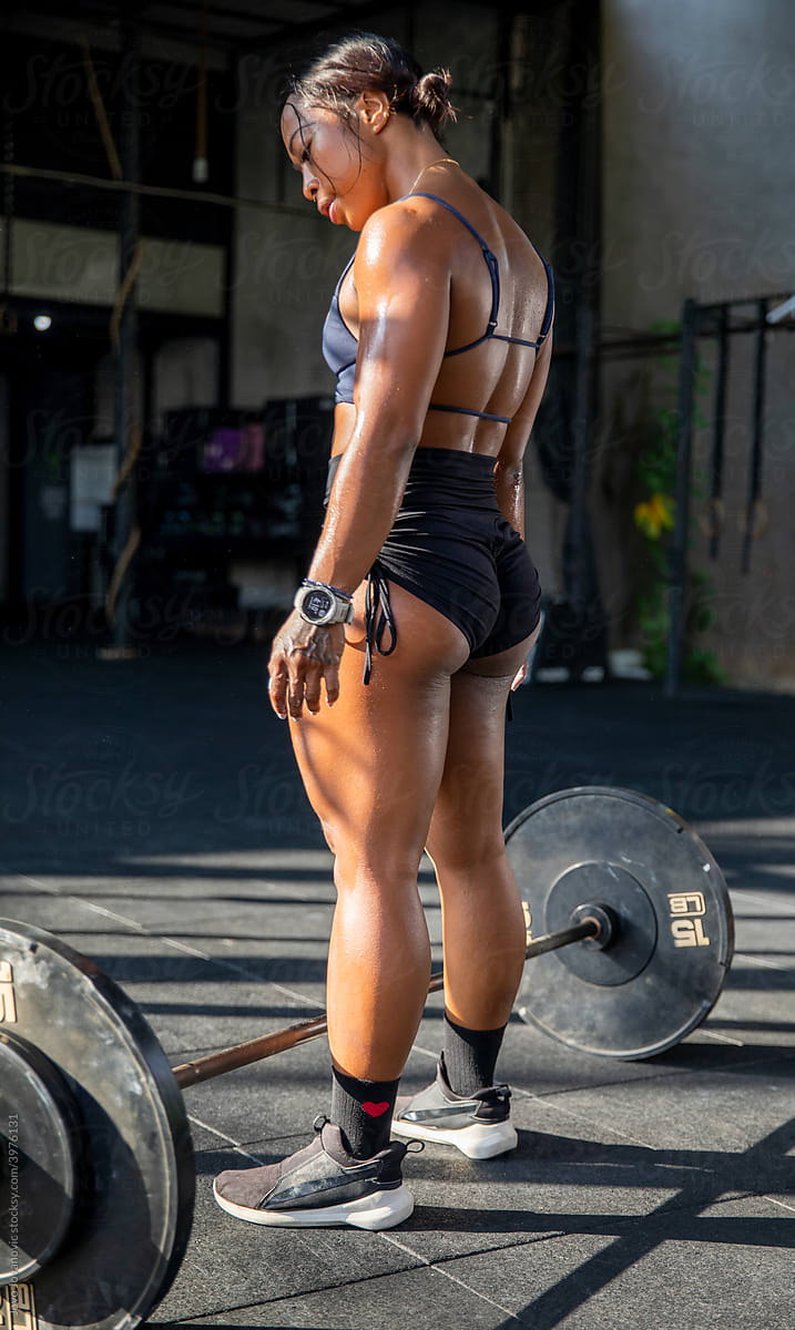 Athletic woman showing muscular legs in gym Stock Photo