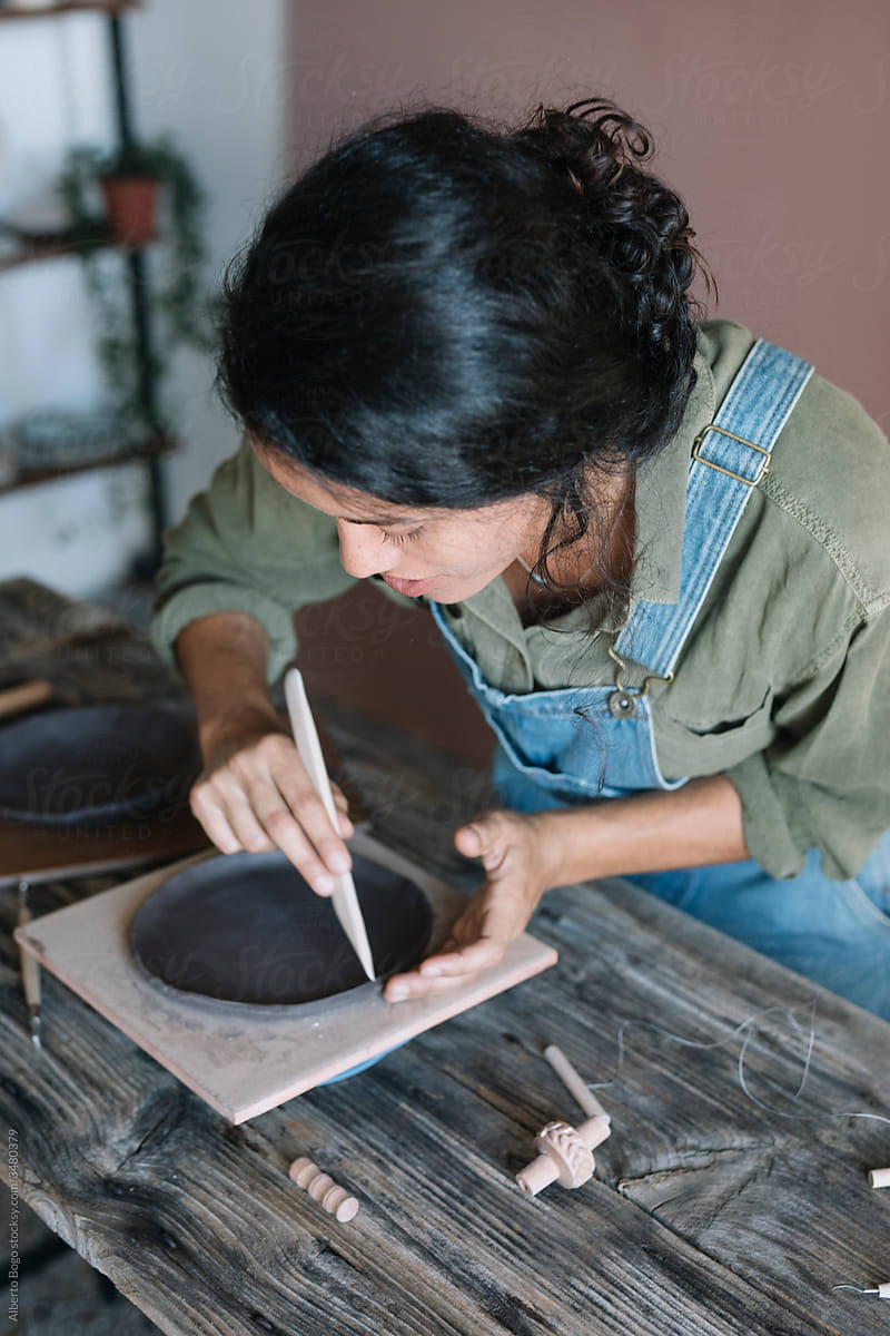 Young woman modeling a ceramic plate