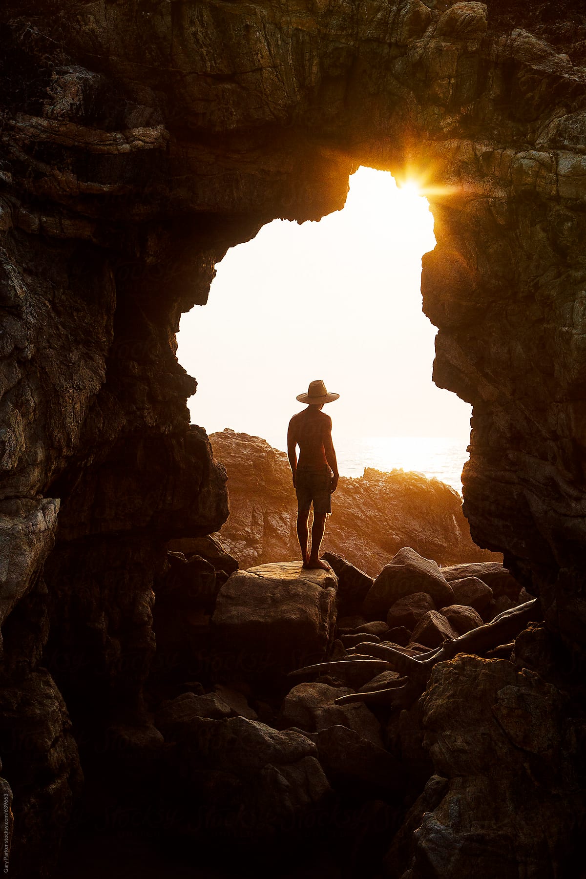 A Man Standing In A Cave Watc