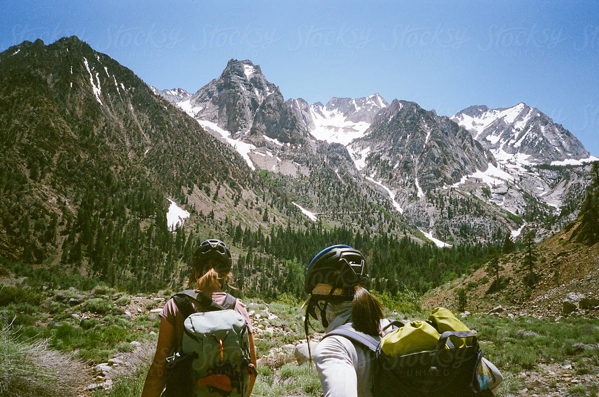 Adventurous Women Wearing Climbing Helmets Hiking in the Wilderness