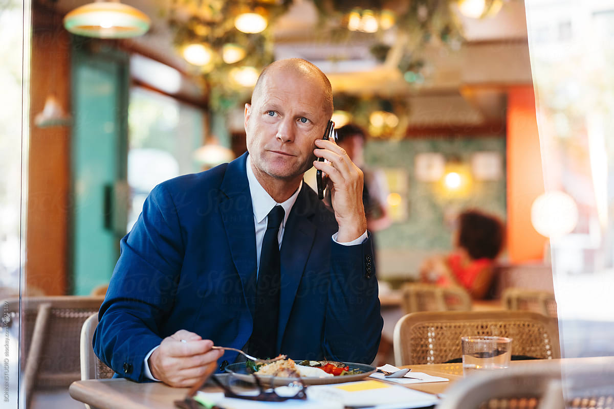 Businessman making phone call during lunch