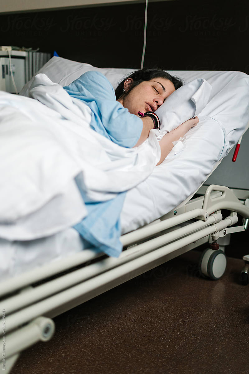 Pregnant woman sleeping in cozy hospital bed