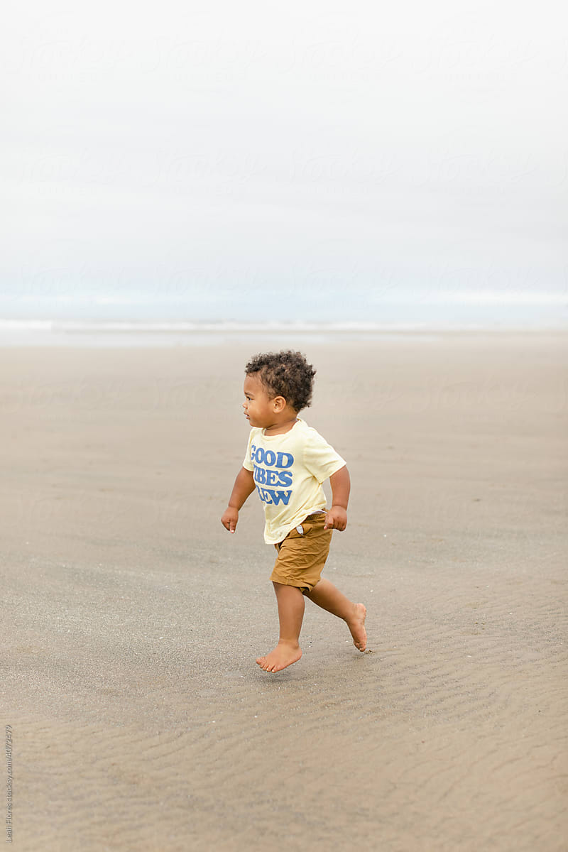 Cute Child Running on Sandy Beach