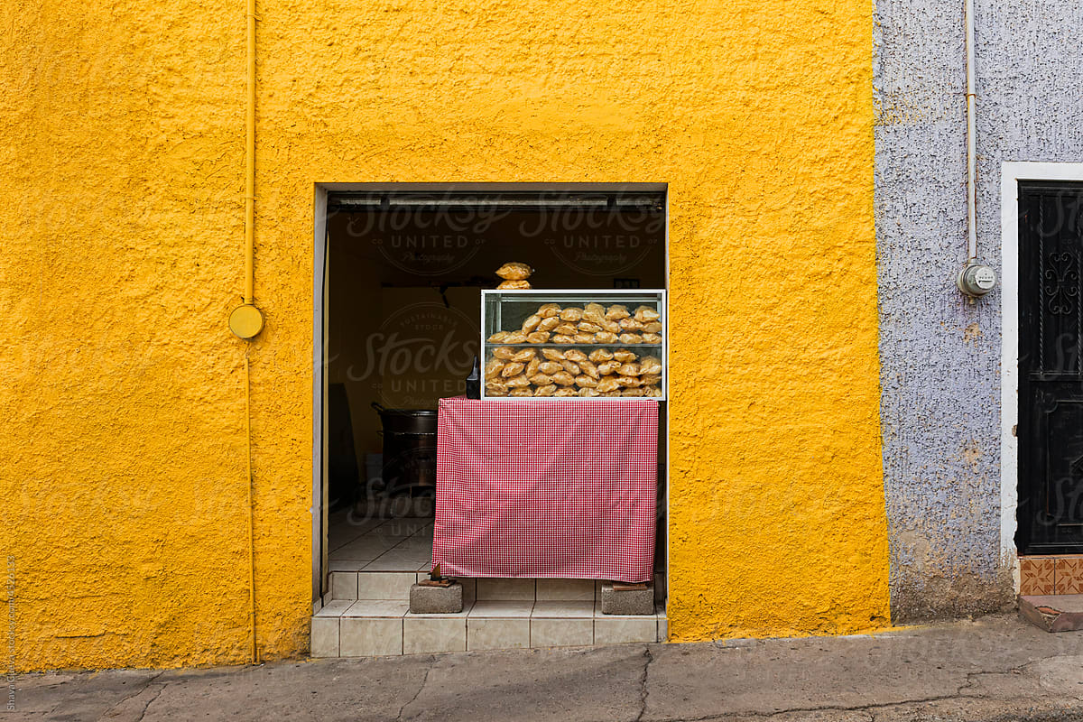 A street food stall in the middle of a yellow walls
