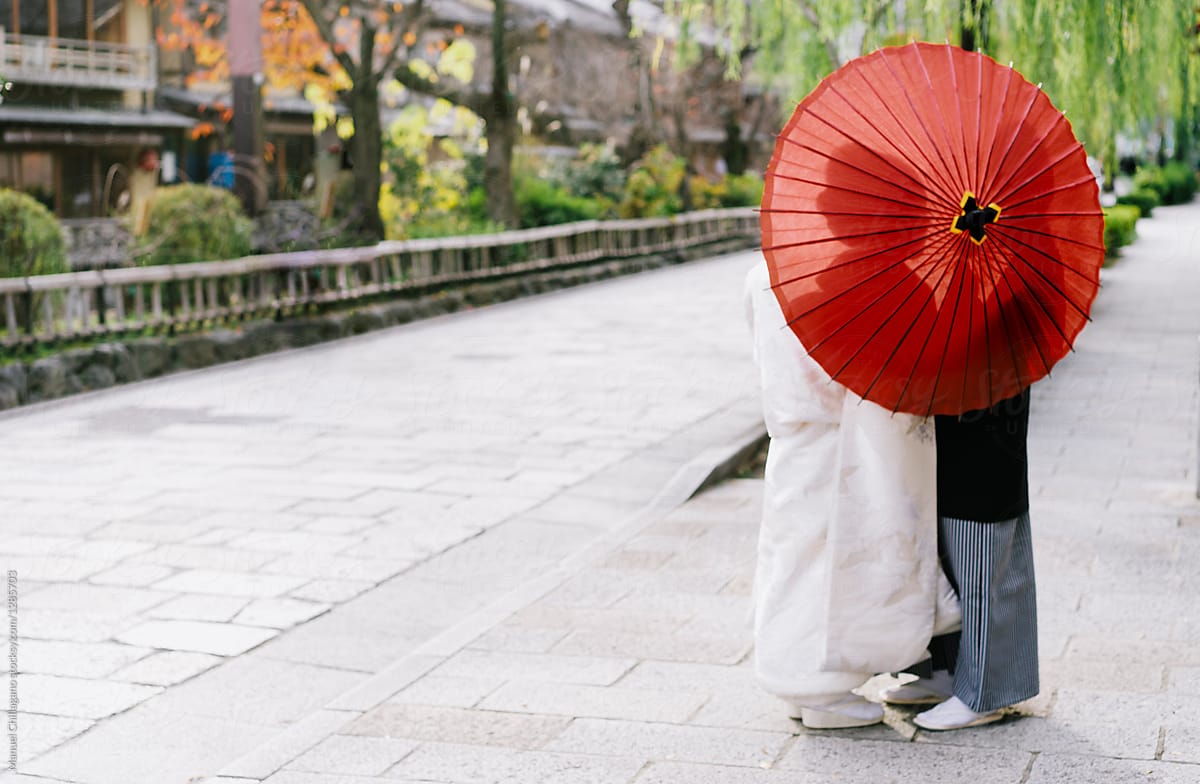 Silhouette of couple behind umbrella in traditional Japanese clothing