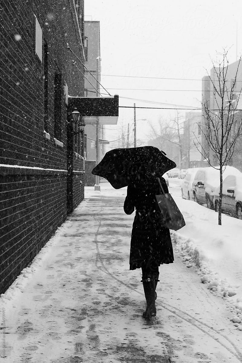 Woman walking through snowstorm.
