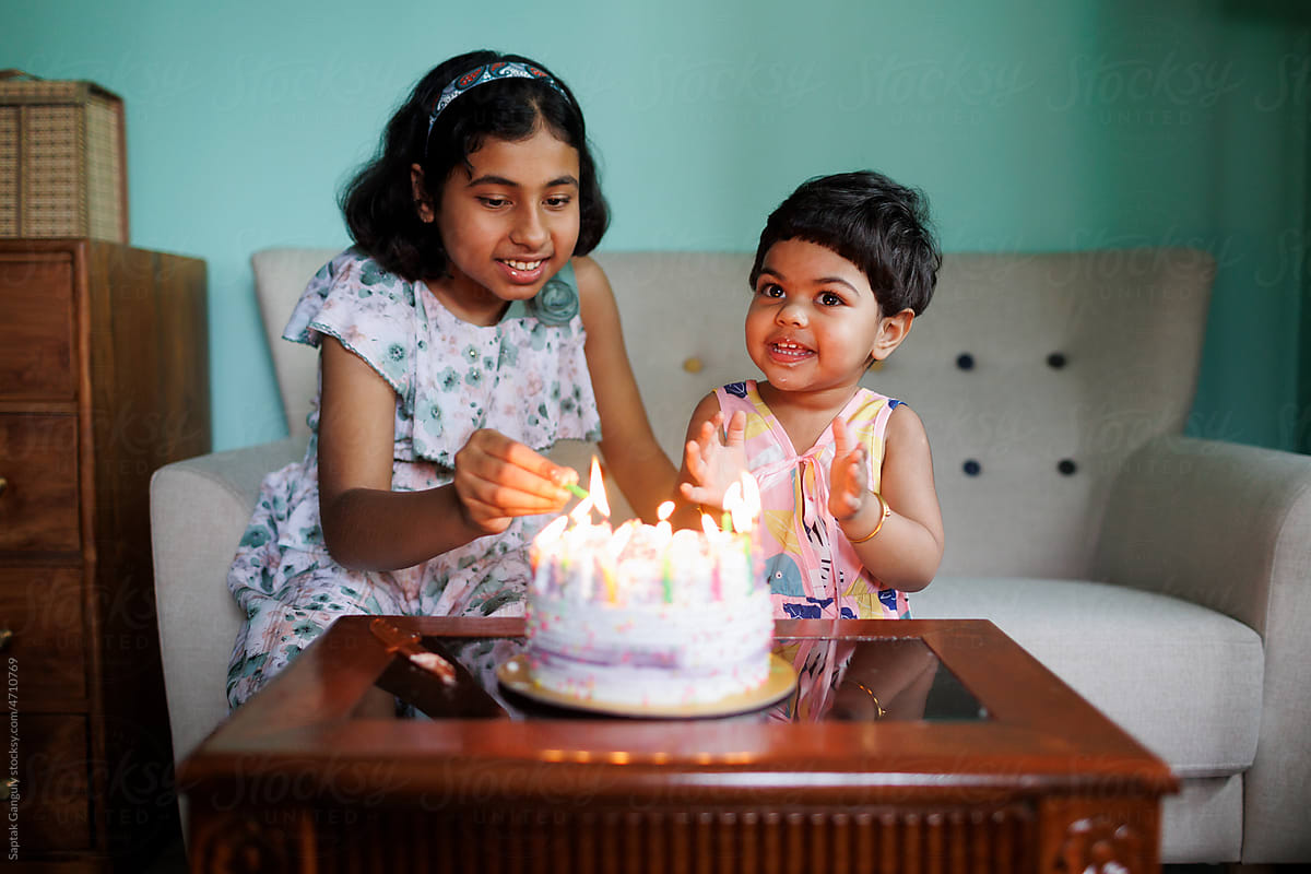 Baby girl celebrates her birthday with elder sister