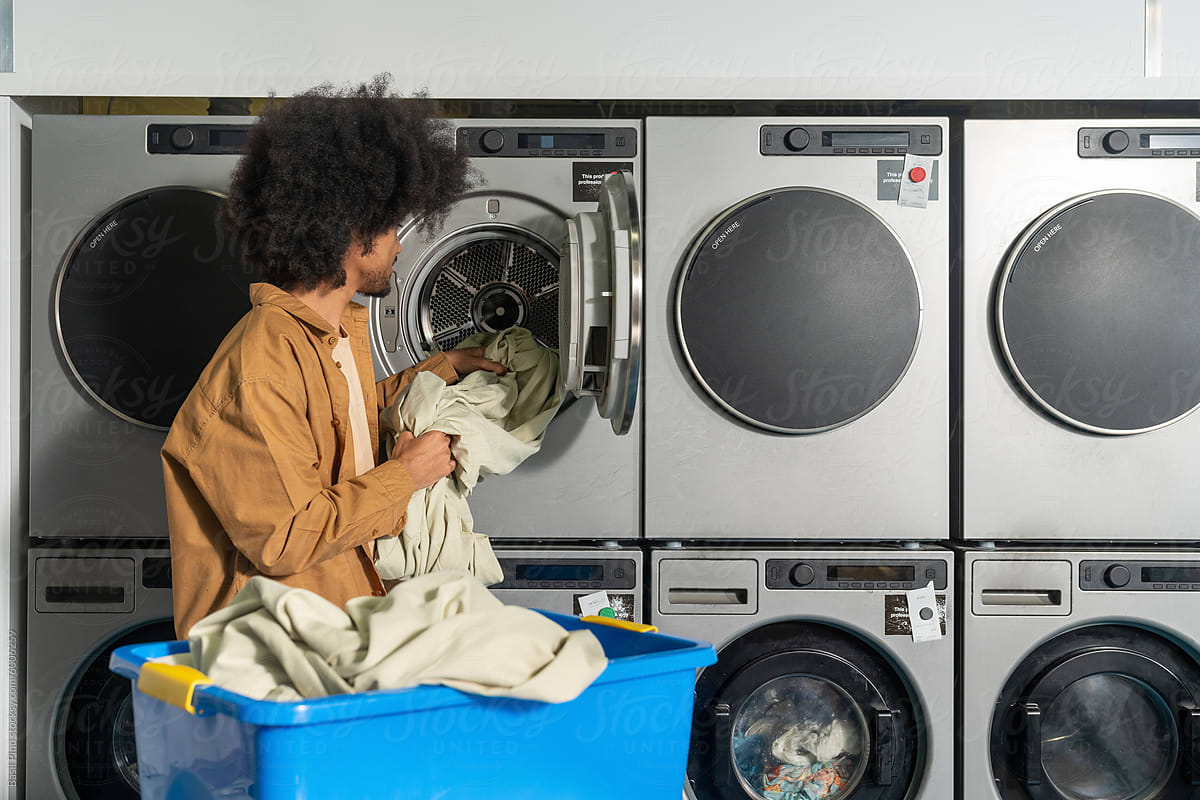 Man Removing Laundry from Dryer
