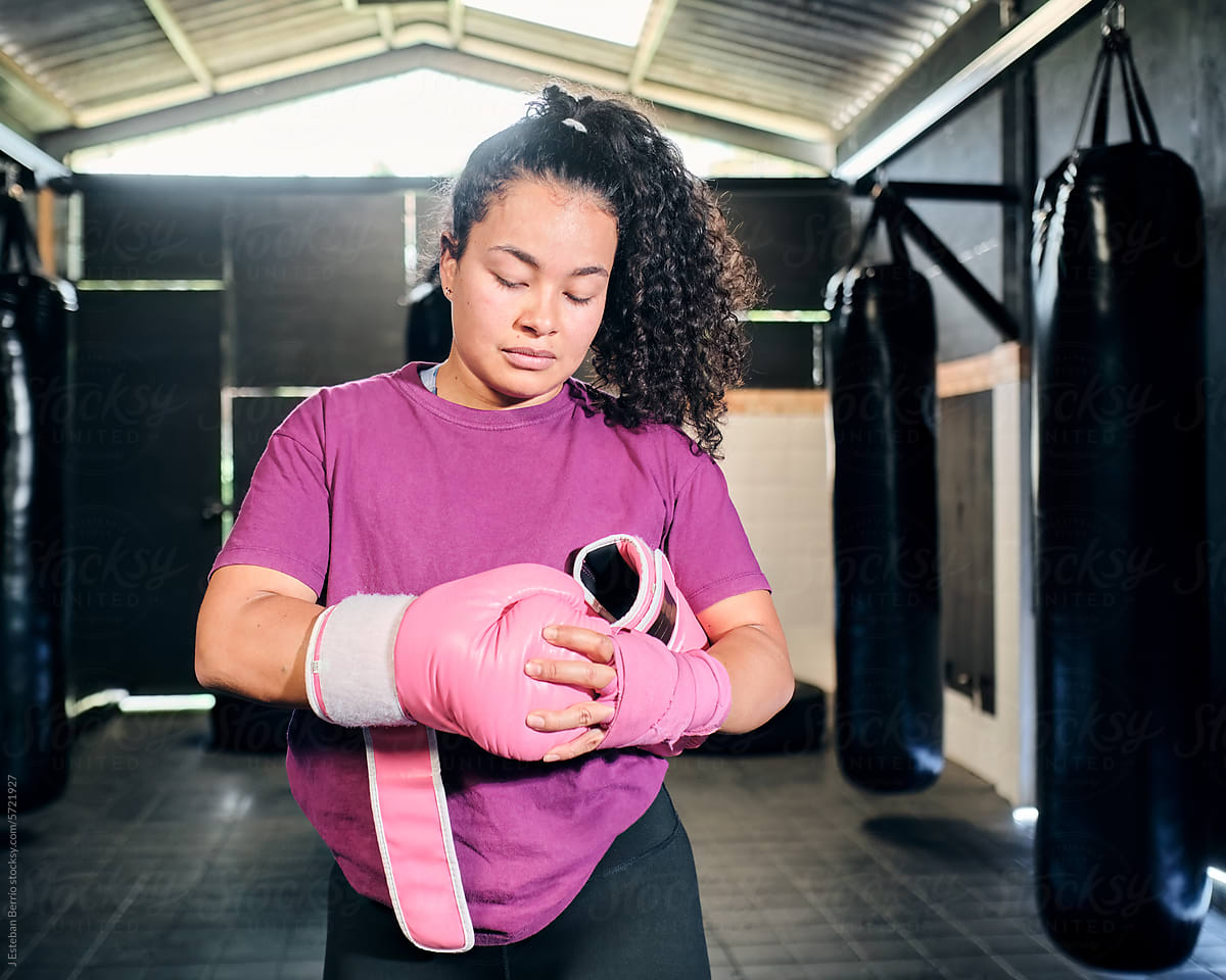 Woman putting on boxing gloves