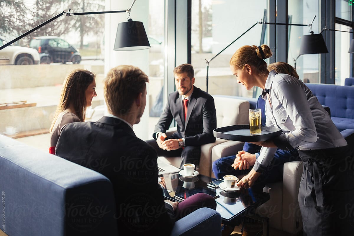 Group of Business People Sitting at a Café