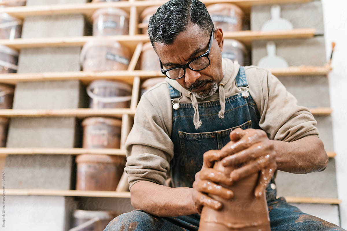 Mature master creating clay pot