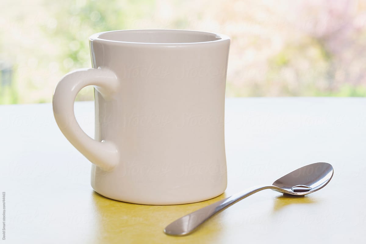 Retro coffee mug and spoon on diner counter near window