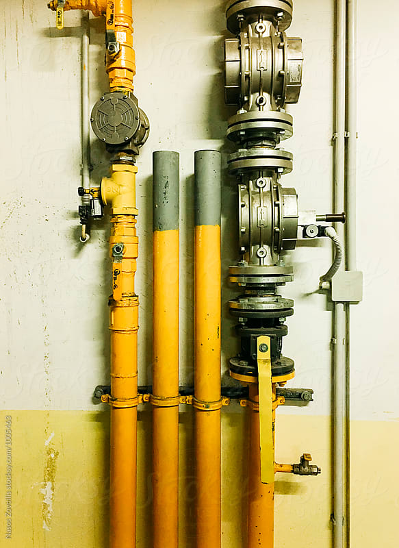 Electrical cables tube and compressor pipe over grungy wall