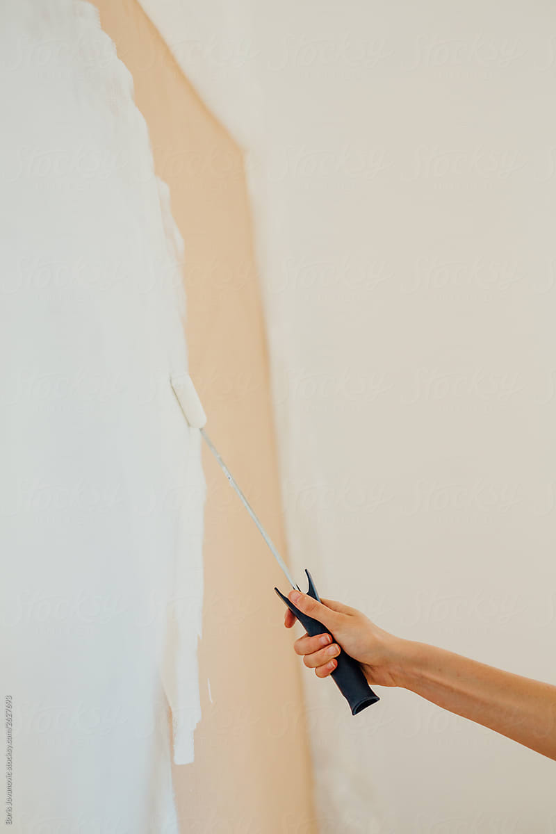 Woman painting a wooden panel