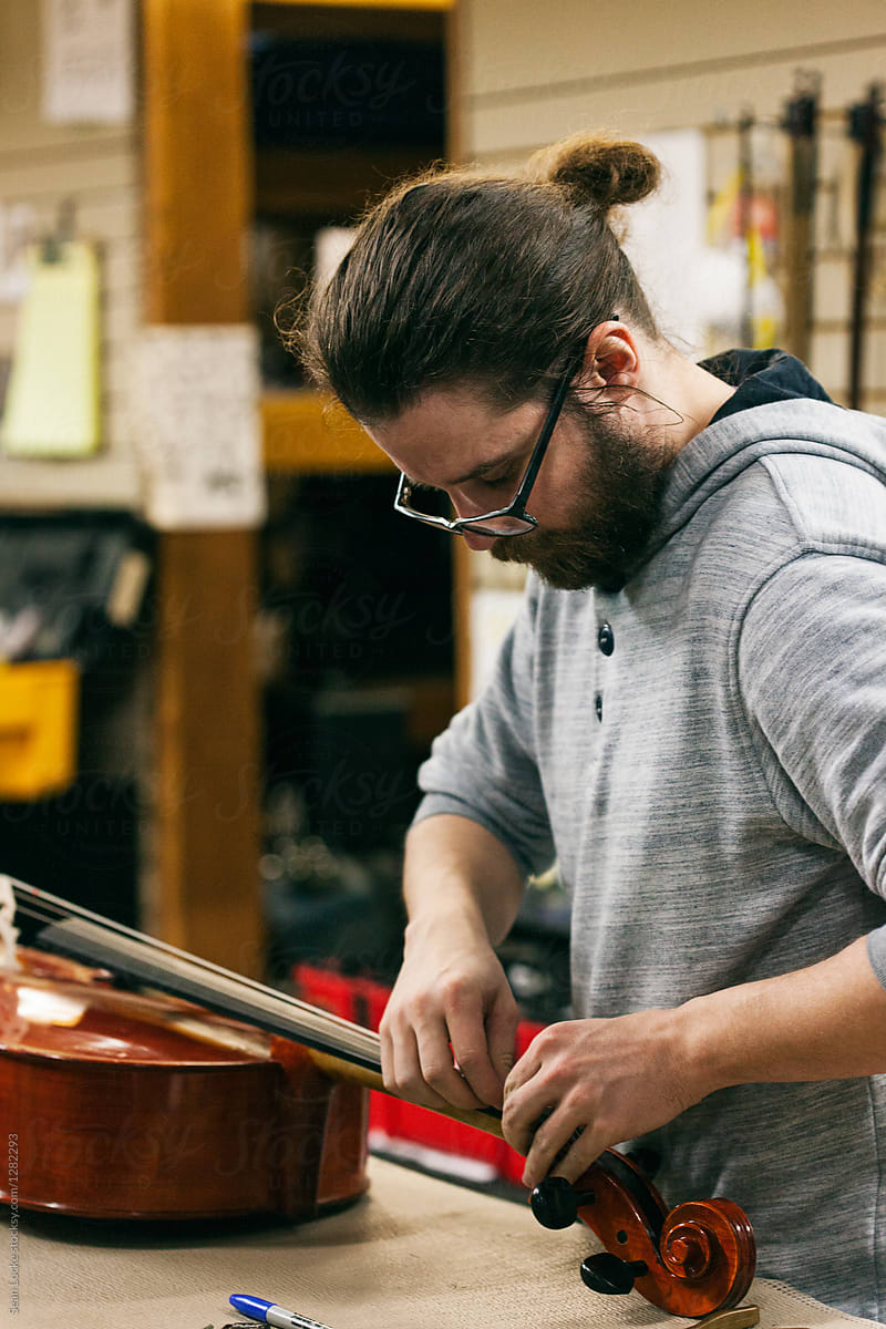 Band: Repairman Replacing Strings On Cello