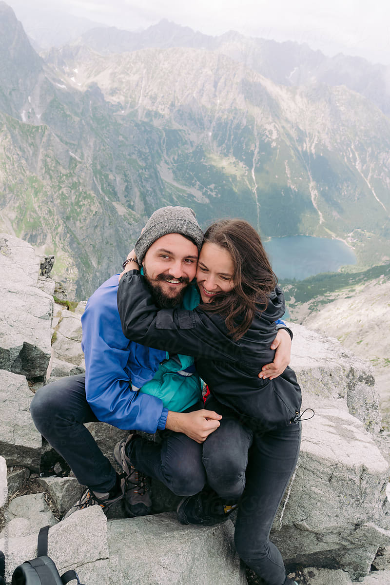 Happy and cheerful couple feeling in love on mountain.
