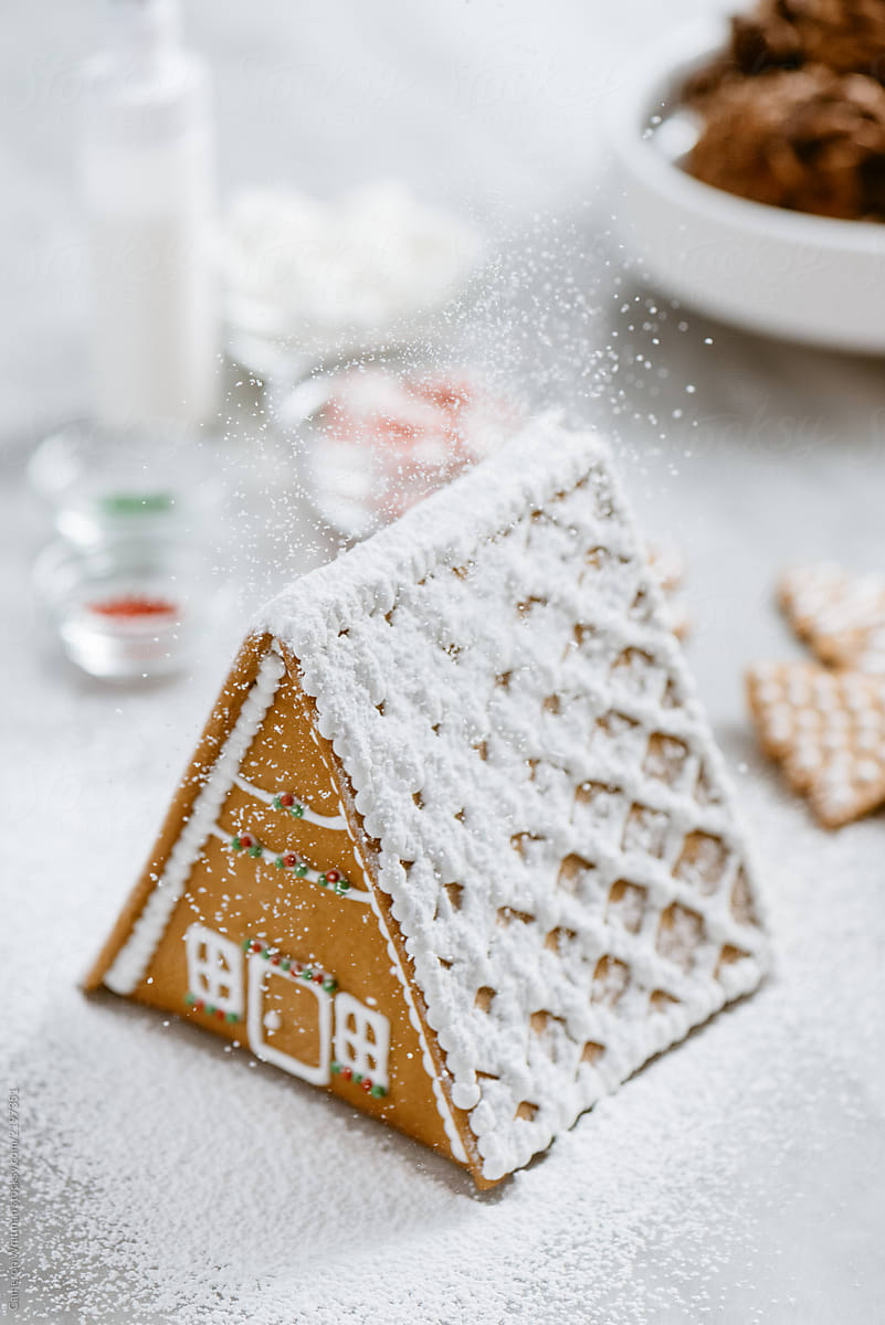 Gingerbread house with falling snow (confectioners sugar)