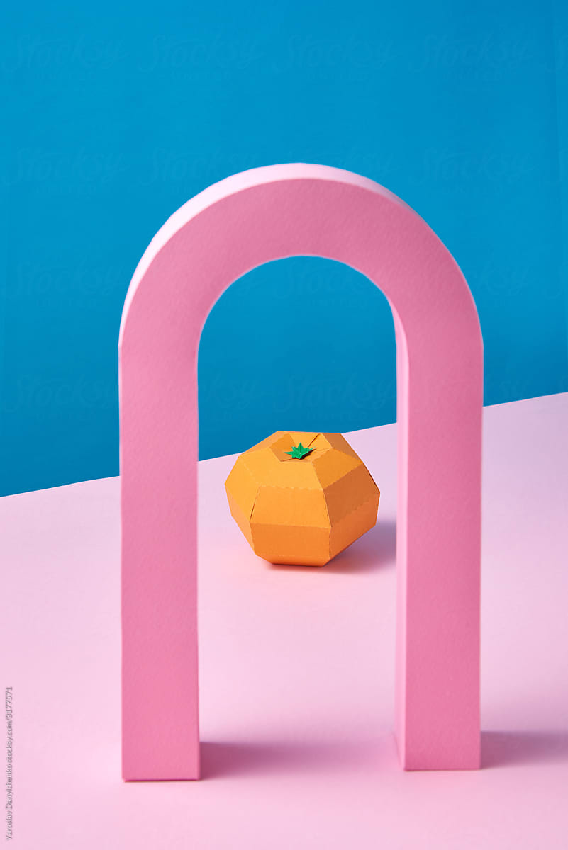 Handmade tangerine fruit under pink arch.
