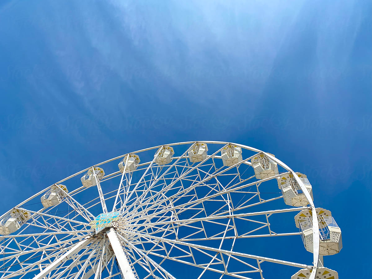 Ferris wheel agains the bright blue summer sky.