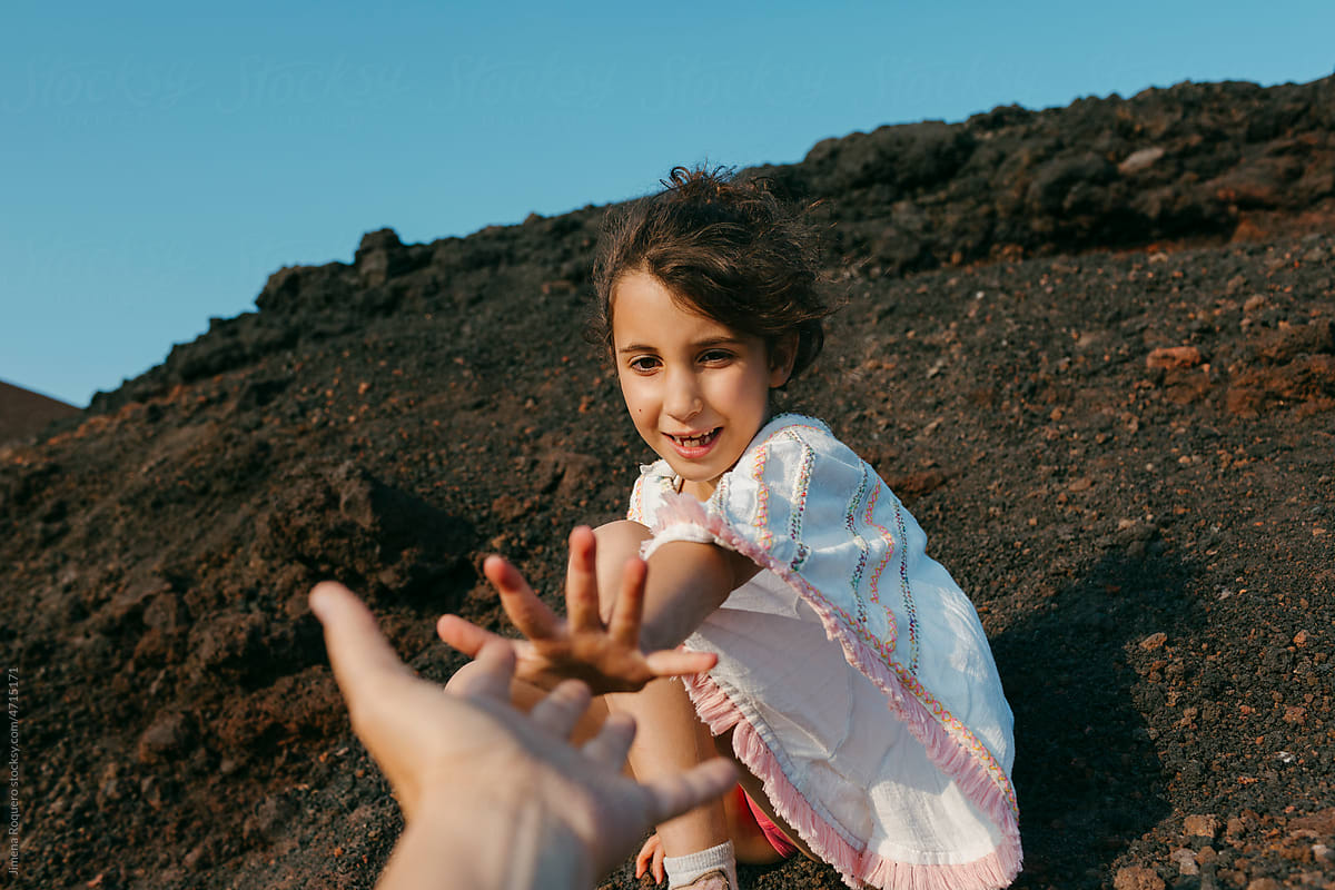 POV of kid in Mount Etna volcano crater holding hand of her mom