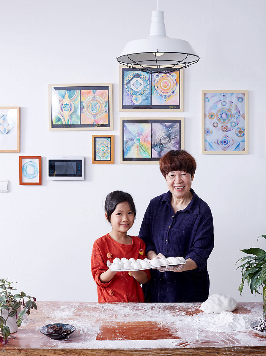 Asian grandmother and little girl, make sweet dumpling