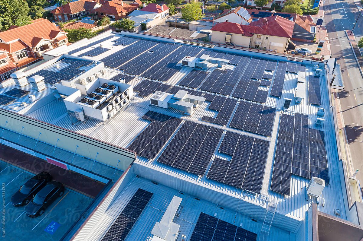Aerial views over commercial building with over 600 solar panels installed