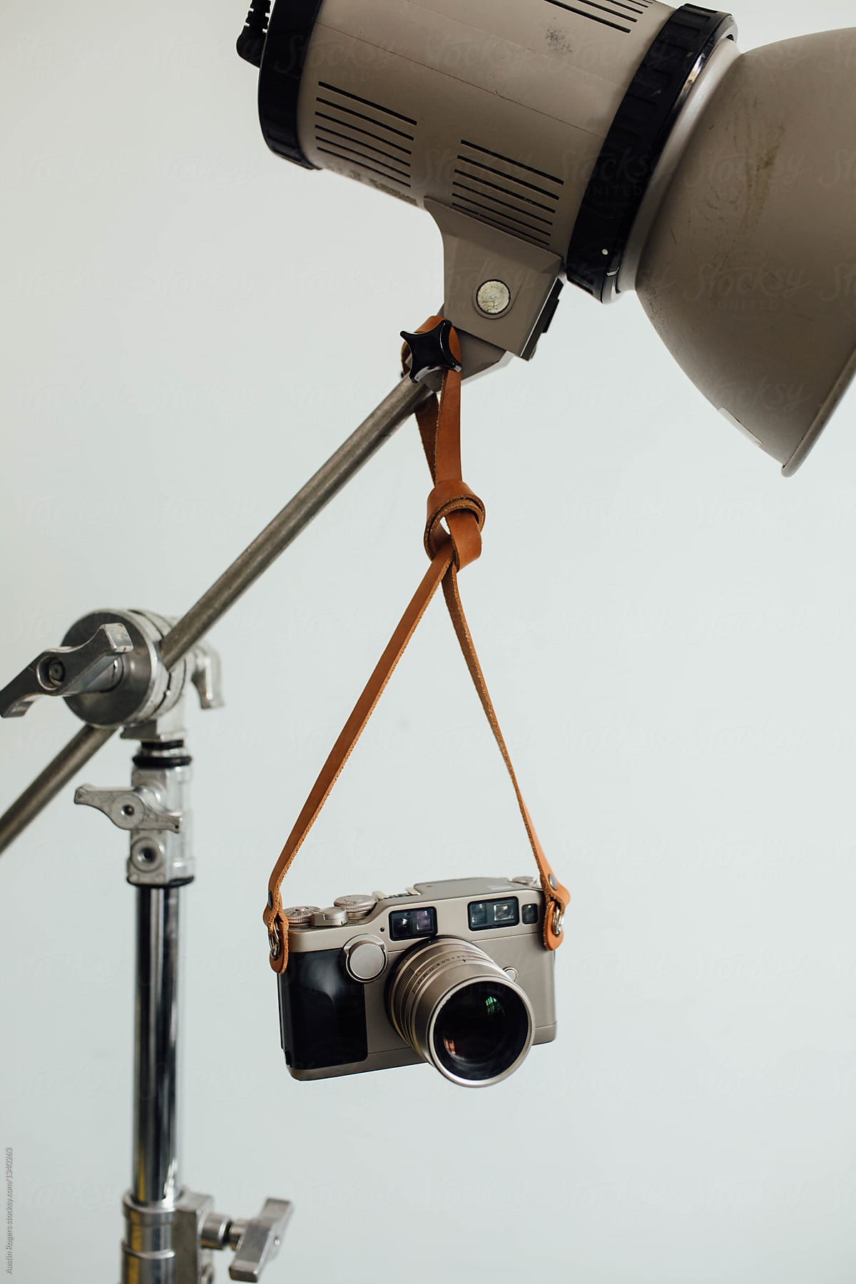 Rangefinder Style Camera Hanging from Strap on Studio Flash