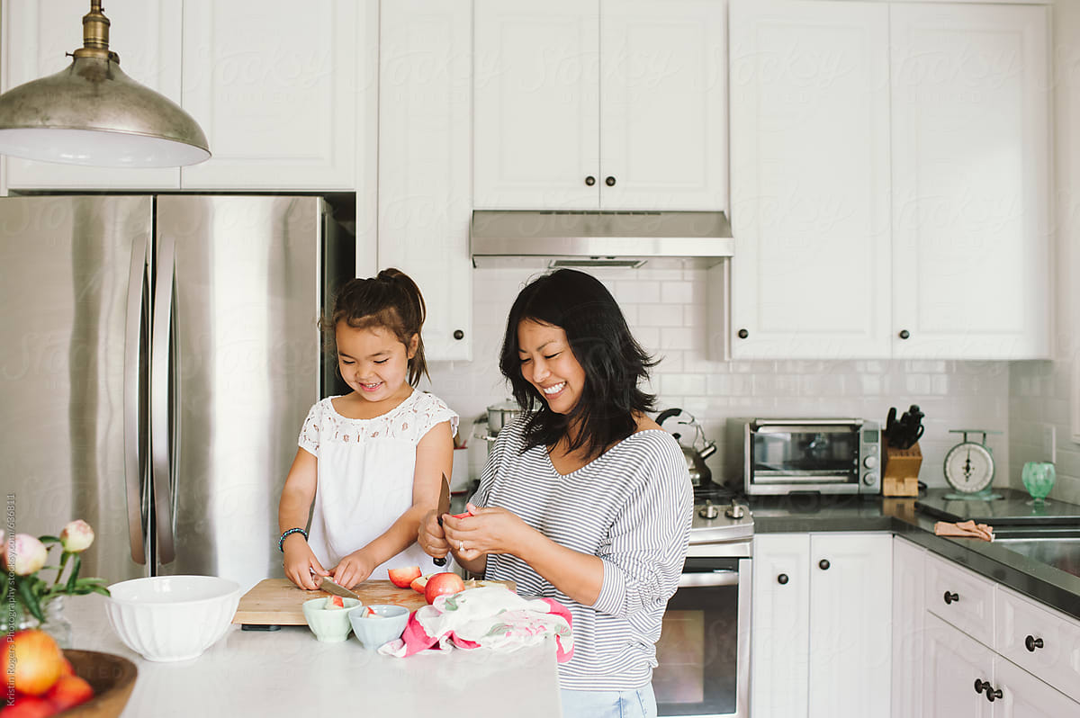 Mom And Daughter Making A Snack Together In Kitchen By Stocksy