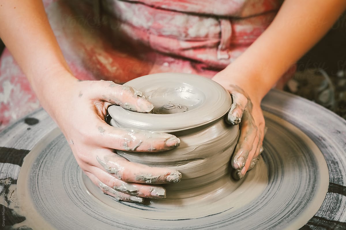 Woman Crafting Ceramics on Pottery Wheel