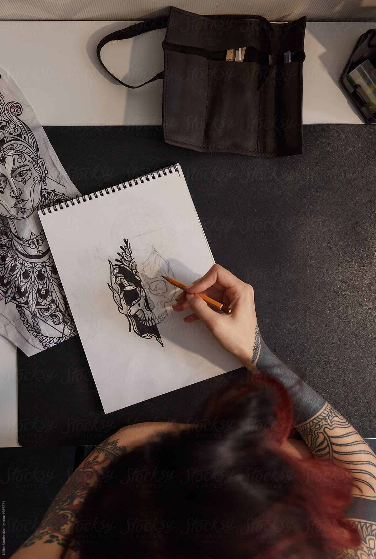 Crop woman creating tattoo sketch