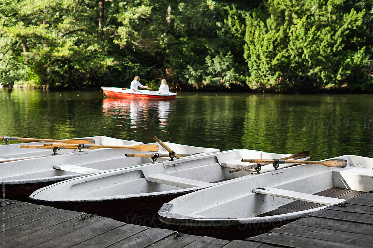Rowboats docked at wooden pier on the lake
