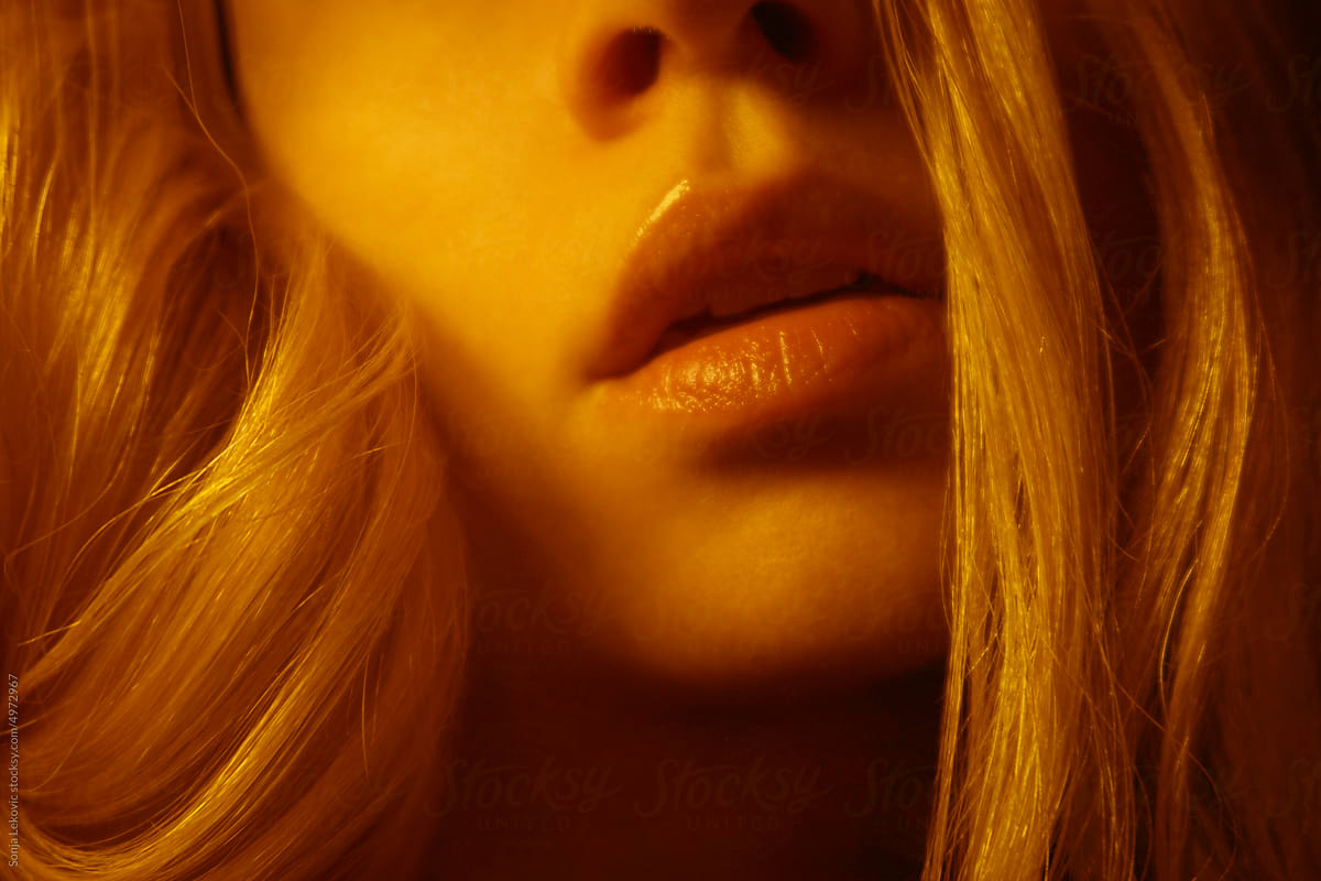 sensual lips closeup in orange light
