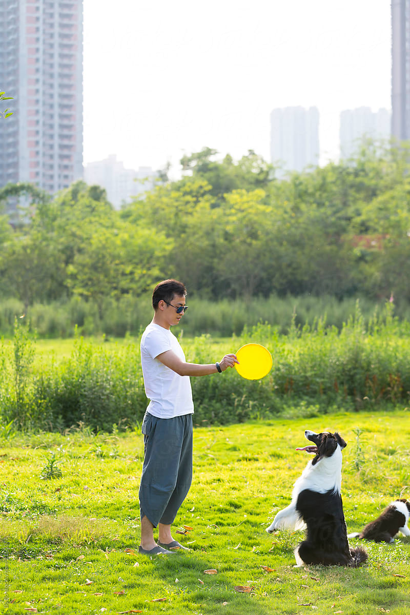 Young asian man with his dog outdoor