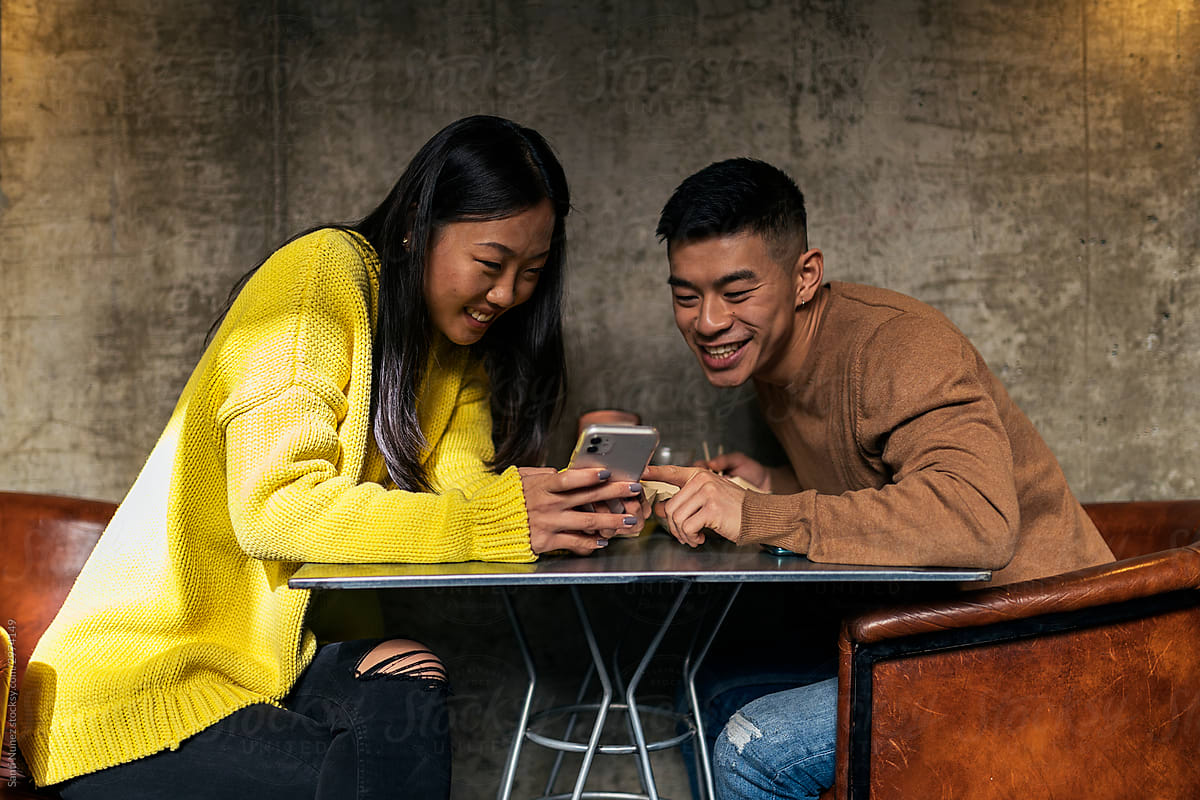 Chinese couple looking at smartphone.