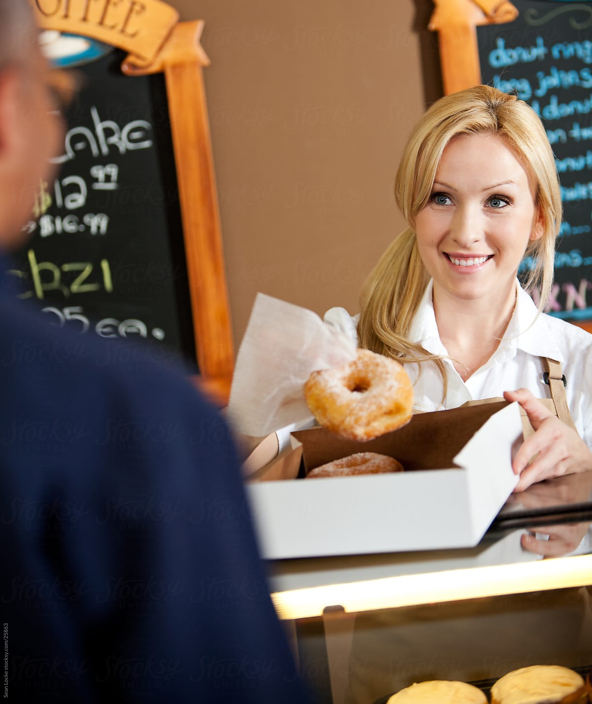 Bakery: Employee Boxing Up Donuts for Customer