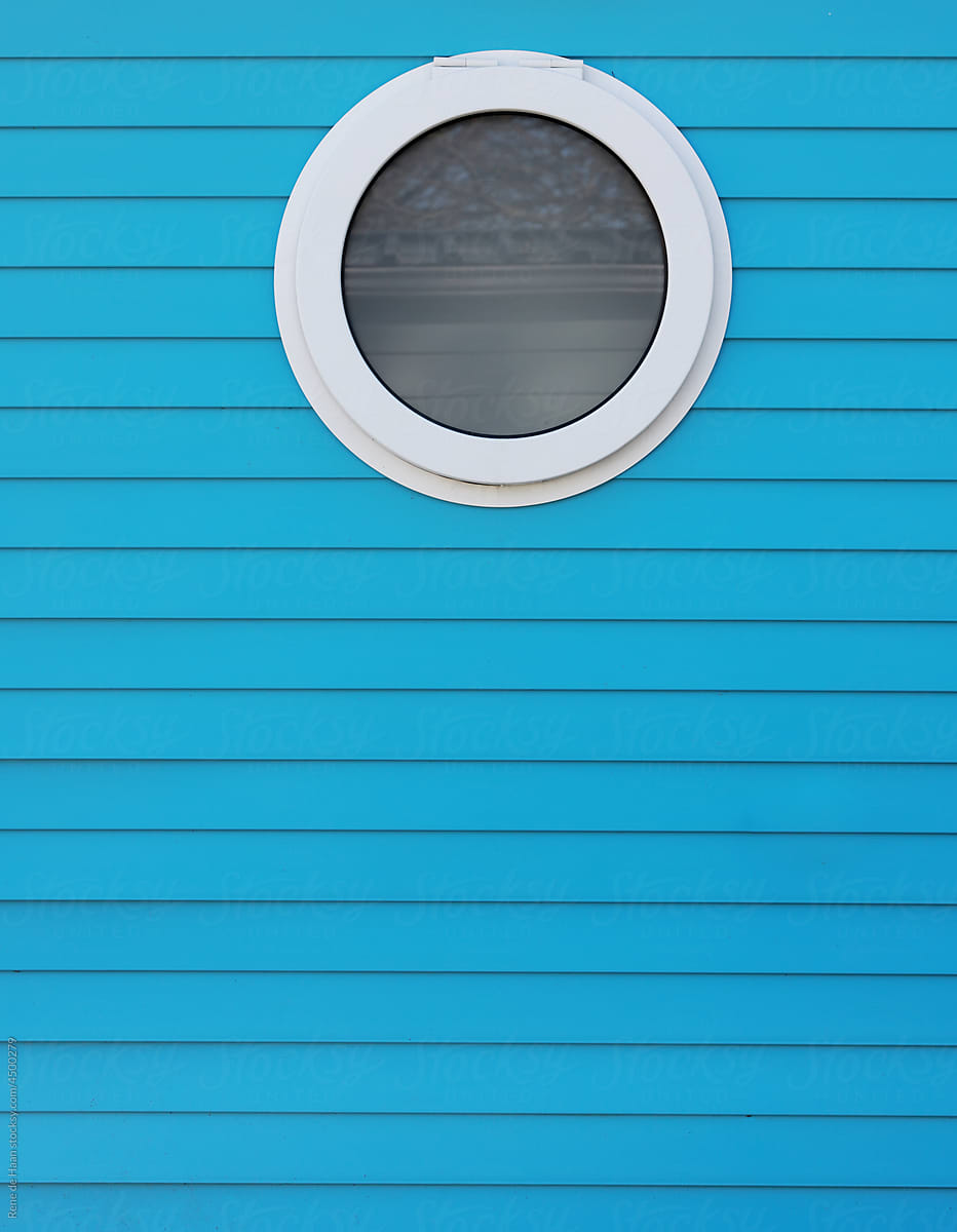 round window in blue wall